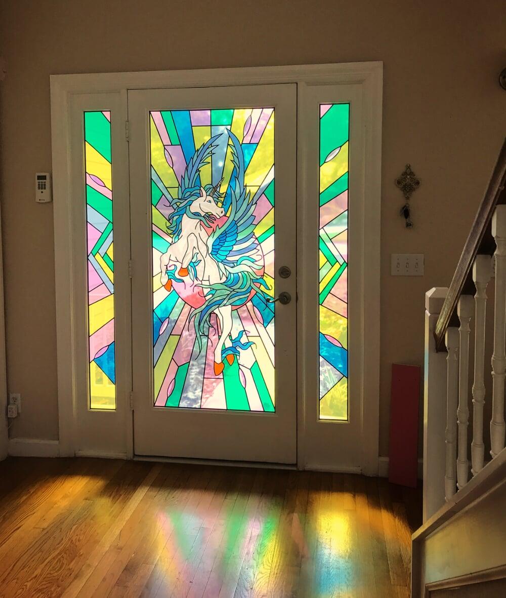 Glass design of vibrant unicorn in door entryway