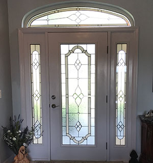 Entry way door, sidelights and transom in traditional stained glass style Entry way door, sidelights and transom in traditional stained glass style
