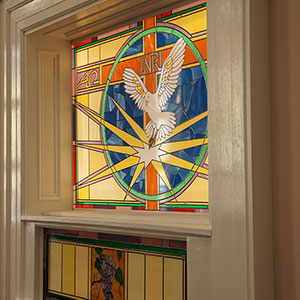 Stained Glass light box in front of baptismal font