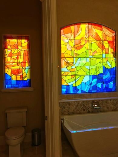 Sunrise over water bathroom windows